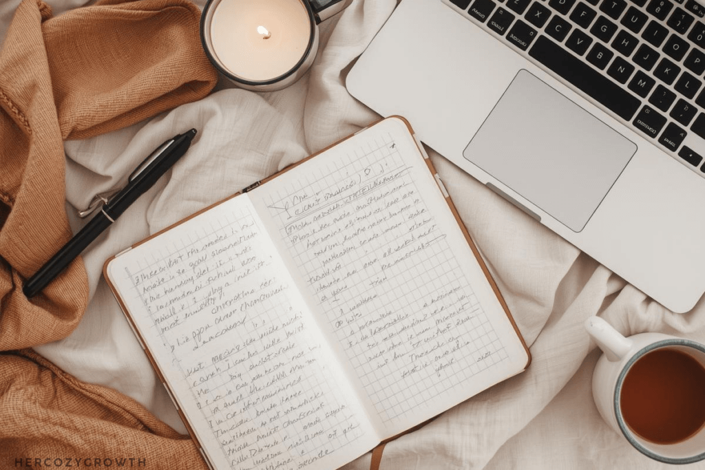 cozy flat lay with notebook and laptop featuring chatgpt prompts for productivity